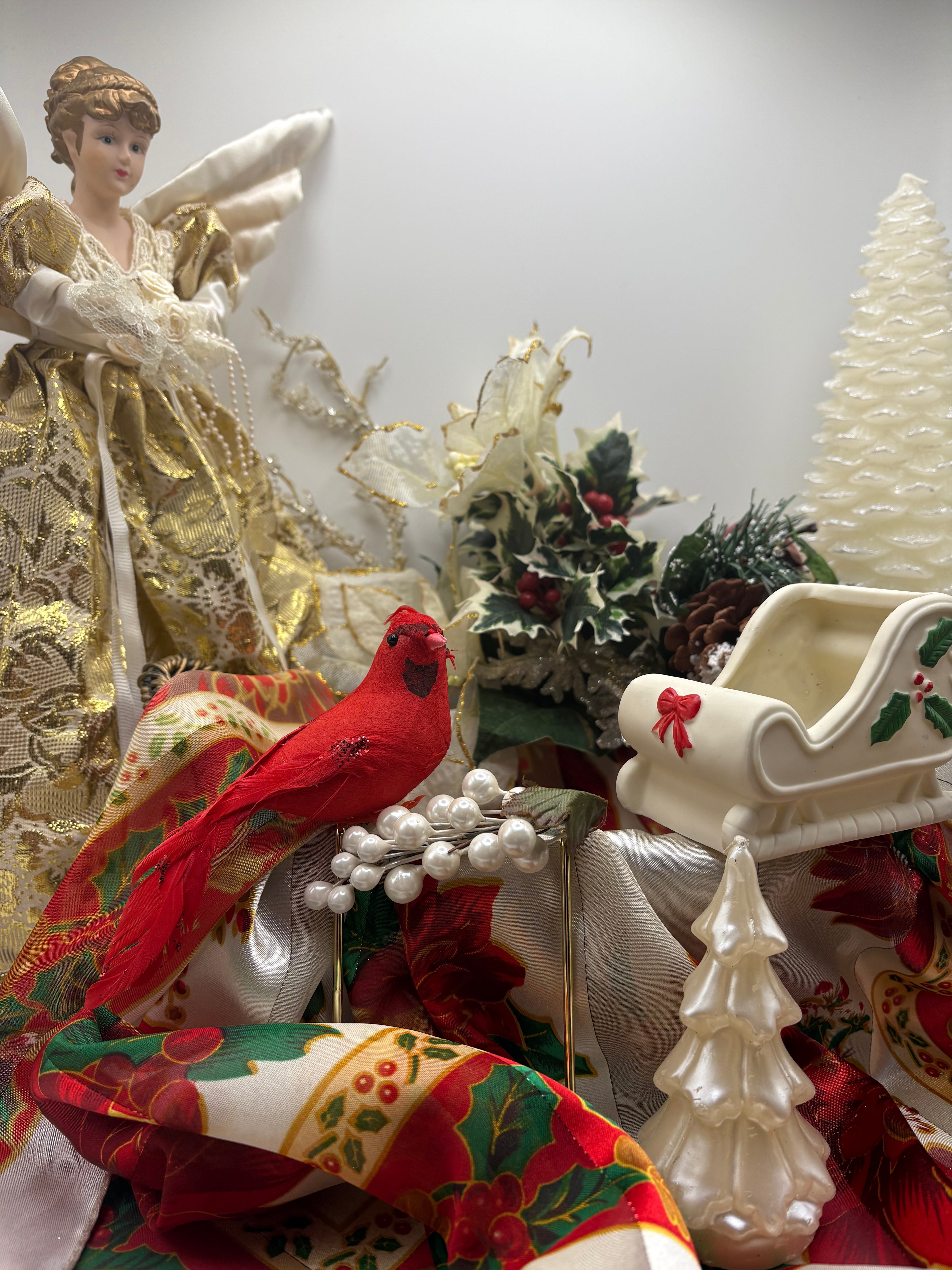 Decorative Christmas scene with angel, bird, and ornaments on a white background